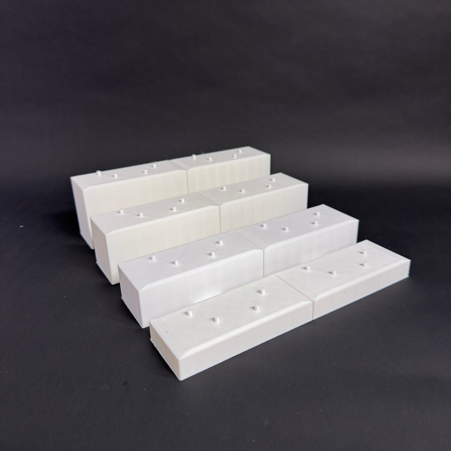 Interlocked Figure Floor bases arranged in a tiered setup